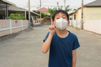 Portrait of boy standing on street