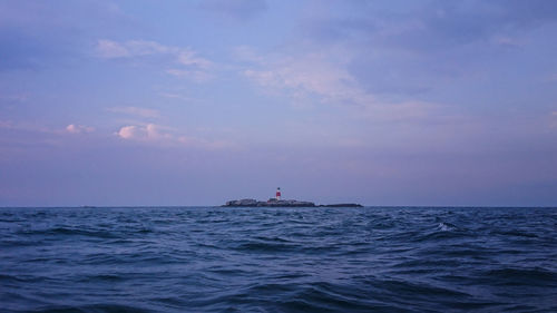 Boat sailing in sea against sky