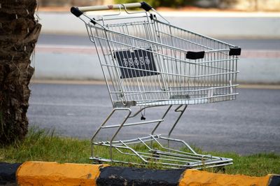 Close-up of shopping cart on road