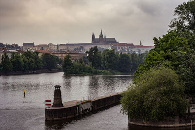 View of bridge over river against cloudy sky