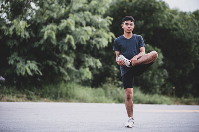 Full length of young man against trees