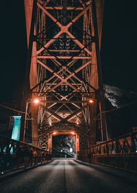 Illuminated bridge at night