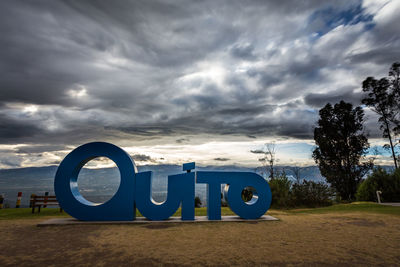 Information sign against sky