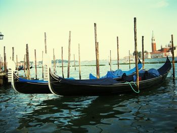 Boats moored in lake against sky