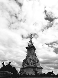 Low angle view of eiffel tower against cloudy sky