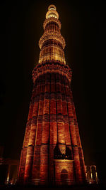 Low angle view of illuminated building against sky at night