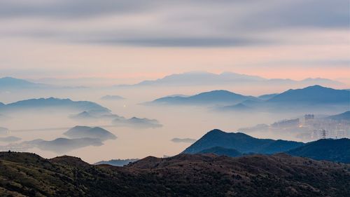 Scenic view of mountains against cloudy sky