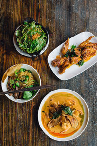 Thai restaurant meal spinach with peanut sauce fried chicken wings coconut prawn curry noodles