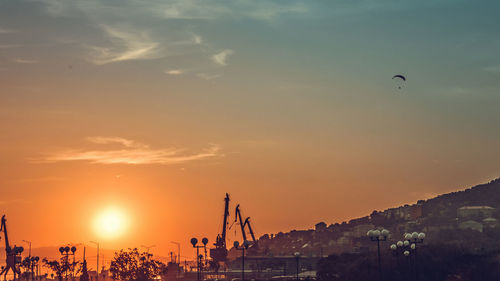 Low angle view of crane at sunset