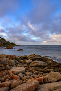 Rocks on beach against sky