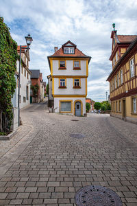 Street amidst buildings in city against sky