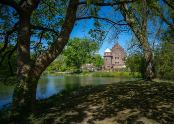 Reflection of trees and building in lake