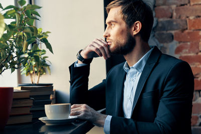 Midsection of man with coffee