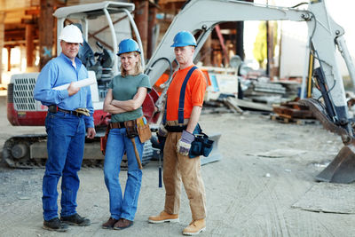 Group of construction workers looking at camera standing in fron