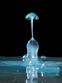 Close-up of water splashing over black background