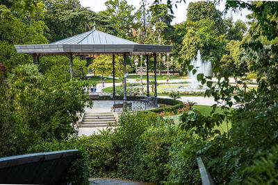 Gazebo by swimming pool in park