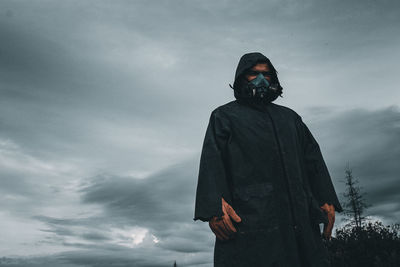 Low angle view of man standing against sky