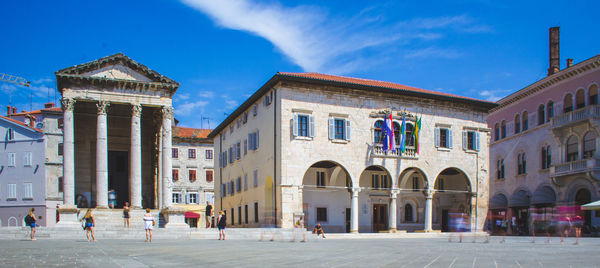 Facade of historic building in city against sky