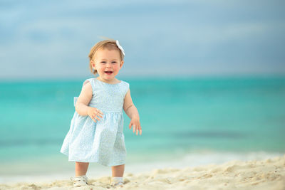 Portrait of happy girl standing on beach