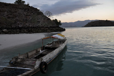 Boat moored on sea against sky