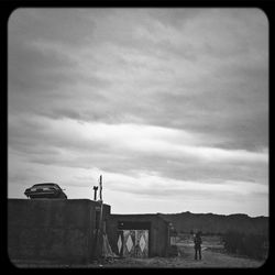 Silhouette of people against cloudy sky