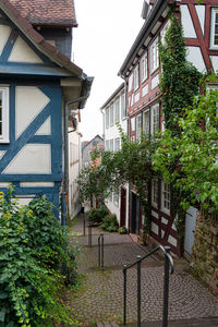 Street by buildings in town against sky