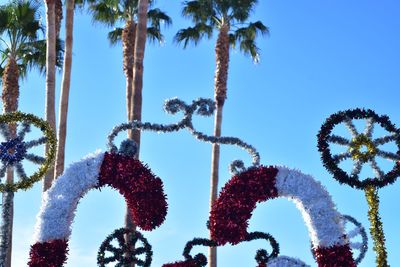 Low angle view of palm trees against blue sky