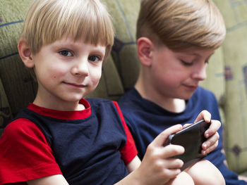 Portrait of boys using mobile phone