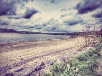 Scenic view of landscape against cloudy sky