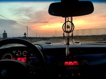 Vintage car on road against sunset sky