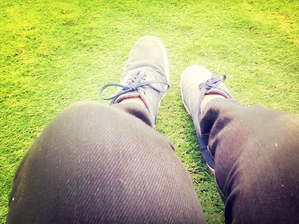 grass, low section, field, person, grassy, personal perspective, shoe, green color, men, lifestyles, relaxation, leisure activity, part of, outdoors, human foot, day, sunlight