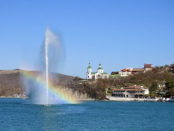 View of rainbow over buildings in city