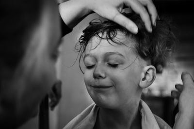 Close-up portrait of a boy at hairdress