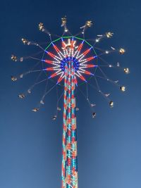 Low angle view of illuminated ferris wheel against sky at night