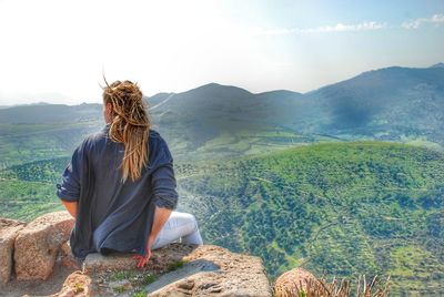 Rear view of man looking at mountains