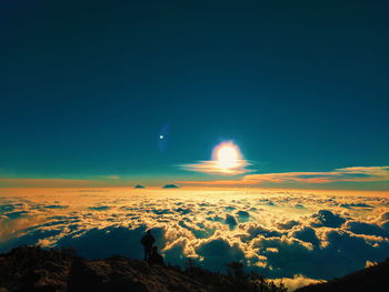 Scenic view of landscape against blue sky during sunset