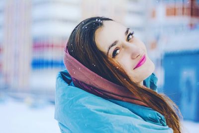 Portrait of smiling young woman during winter