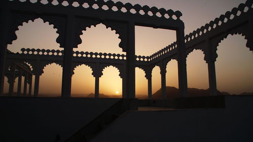 Built structure against sky at sunset