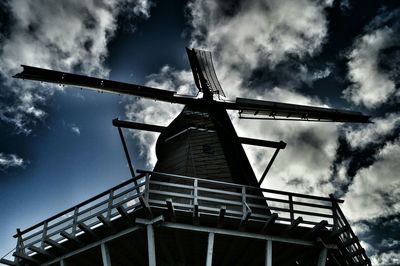 Low angle view of windmill against cloudy sky