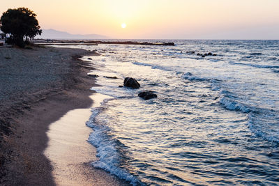 Scenic view of beach against sky during sunset