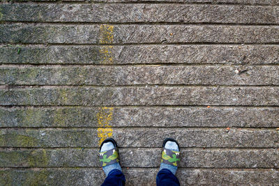 Low section of man standing on footpath