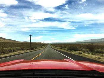 Road by landscape against sky