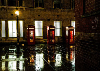 Reflection of illuminated building on wet window at night