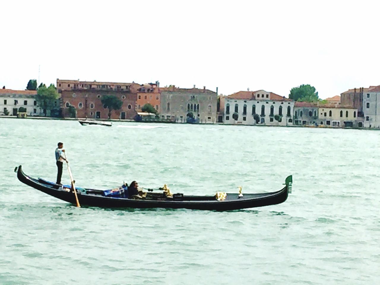 water, nautical vessel, boat, transportation, waterfront, mode of transport, building exterior, built structure, architecture, clear sky, moored, rippled, river, sailing, canal, men, day, travel, sea