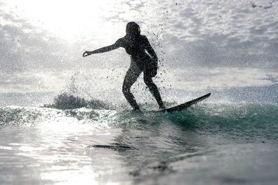 Side view of man surfing in sea