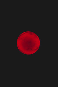 Red moon against black background