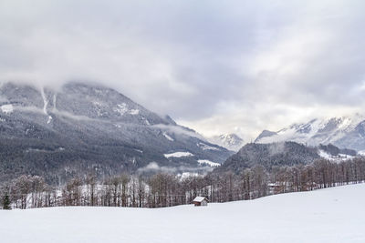 Scenic view of snow covered mountains against sky