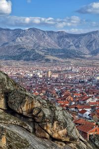 Aerial view of illuminated cityscape against sky