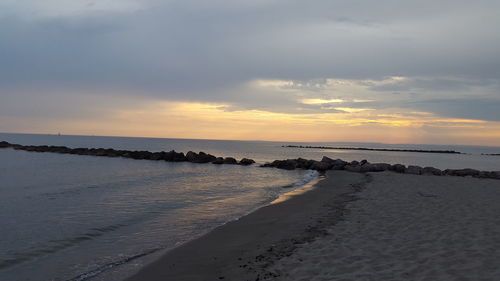 Scenic view of beach against sky during sunset