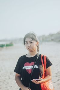 Portrait of teenage girl standing on beach